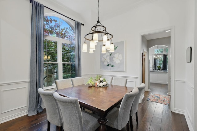 1416 Basil Dr, Flower Mound, TX 75028 - dining space with a chandelier, dark wood-type flooring, a decorative wall, and a wainscoted wall
