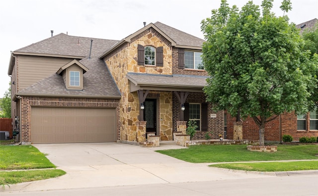 10909 Blake Gdns, Mckinney, TX 75072 - traditional home featuring a front lawn, covered porch, a shingled roof, concrete driveway, and brick siding