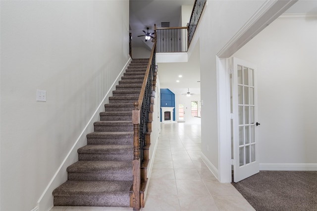 10909 Blake Gdns, Mckinney, TX 75072 - staircase featuring a ceiling fan, tile patterned flooring, and baseboards