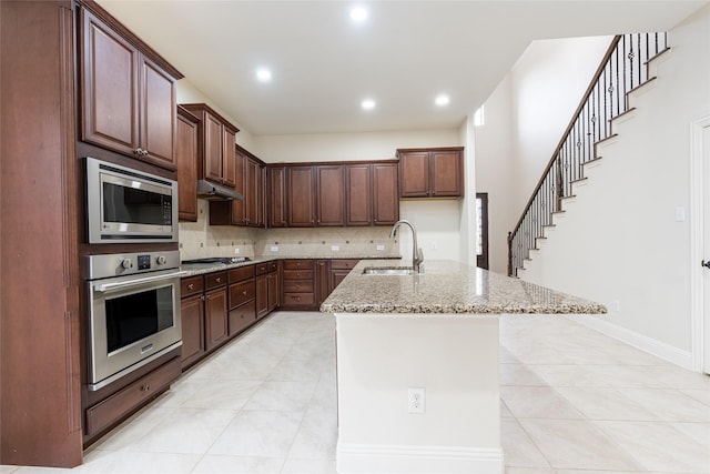 10909 Blake Gdns, Mckinney, TX 75072 - kitchen with stainless steel appliances, a sink, light tile patterned floors, light stone counters, and recessed lighting