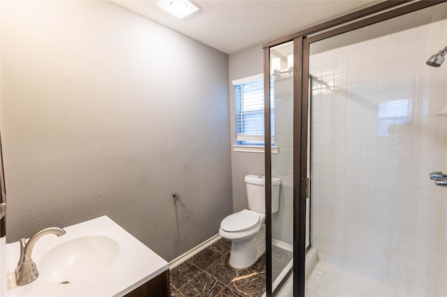 3015 Oak Dr, Rockwall, TX 75032 - full bathroom with a stall shower, toilet, vanity, and baseboards