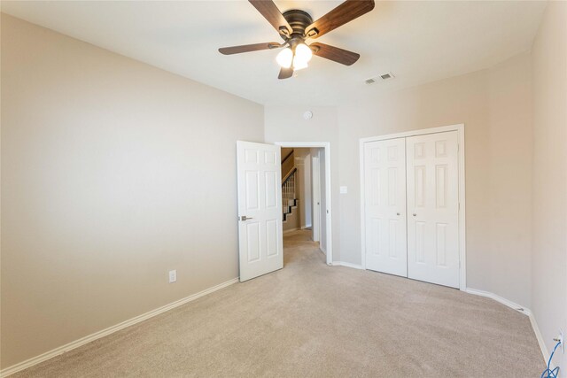 3015 Oak Dr, Rockwall, TX 75032 - unfurnished bedroom with light colored carpet, a closet, baseboards, and a ceiling fan