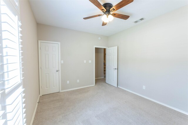 3015 Oak Dr, Rockwall, TX 75032 - unfurnished bedroom featuring light carpet, baseboards, and a ceiling fan