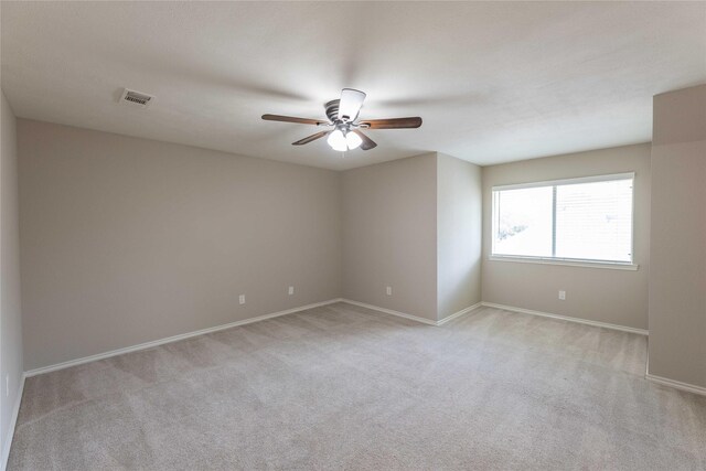 3015 Oak Dr, Rockwall, TX 75032 - spare room with light colored carpet, a ceiling fan, and baseboards