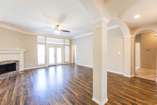 3015 Oak Dr, Rockwall, TX 75032 - unfurnished living room with a ceiling fan, dark wood finished floors, ornate columns, arched walkways, and crown molding