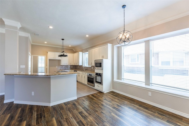 3015 Oak Dr, Rockwall, TX 75032 - kitchen featuring appliances with stainless steel finishes, ornamental molding, dark wood-style floors, stone countertops, and white cabinets
