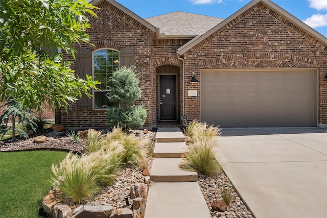 1805 13th St, Argyle, TX 76226 - view of front facade featuring brick siding, concrete driveway, an attached garage, and a shingled roof