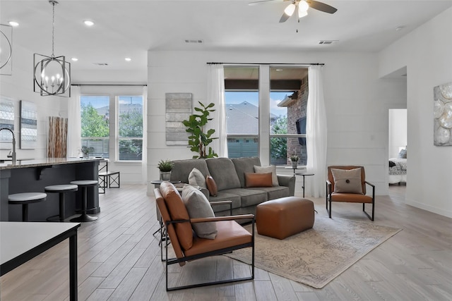 1805 13th St, Argyle, TX 76226 - living area with light wood-style floors, a ceiling fan, a chandelier, recessed lighting, and baseboards