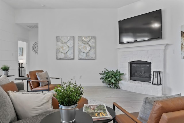 1805 13th St, Argyle, TX 76226 - living area with wood finished floors, a glass covered fireplace, and baseboards