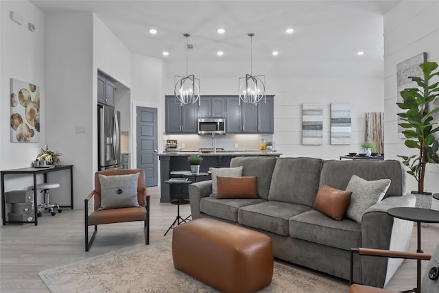 1805 13th St, Argyle, TX 76226 - living area with light wood finished floors, a chandelier, recessed lighting, and a high ceiling