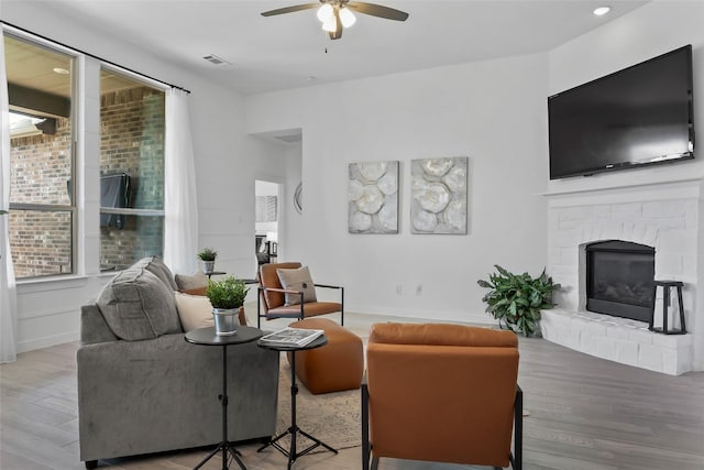 1805 13th St, Argyle, TX 76226 - living room with a ceiling fan, wood finished floors, a fireplace, and baseboards
