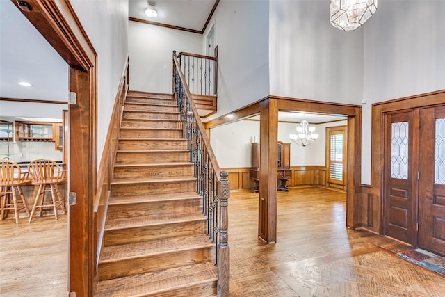3308 Runabout Ct, Plano, TX 75023 - foyer featuring wood finished floors, crown molding, stairs, wainscoting, and a high ceiling