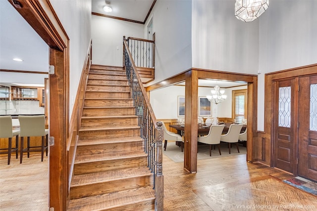 3308 Runabout Ct, Plano, TX 75023 - foyer entrance with stairs, ornamental molding, wood finished floors, wainscoting, and a towering ceiling