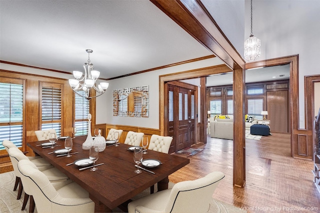 3308 Runabout Ct, Plano, TX 75023 - dining room featuring a chandelier, wood finished floors, ornamental molding, and wainscoting