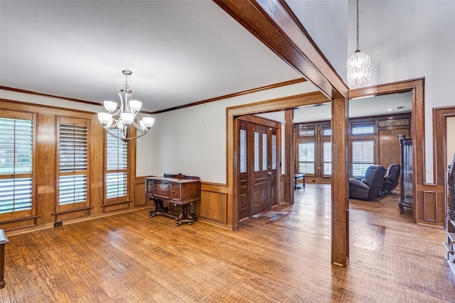 3308 Runabout Ct, Plano, TX 75023 - dining space featuring a chandelier, wood finished floors, a wainscoted wall, and ornamental molding