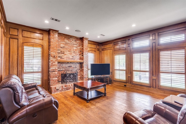 3308 Runabout Ct, Plano, TX 75023 - living area featuring a fireplace, light wood-type flooring, wood walls, and recessed lighting