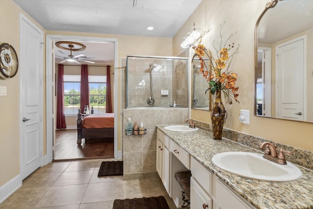 3351 Cascades Ct Unit 306, Tyler, TX 75709 - full bathroom with double vanity, a shower stall, connected bathroom, tile patterned floors, and ceiling fan