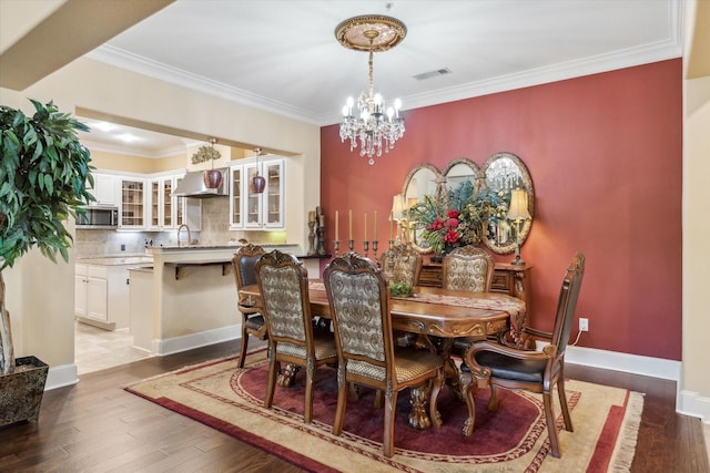 3351 Cascades Ct Unit 306, Tyler, TX 75709 - dining room featuring a chandelier, wood finished floors, crown molding, and baseboards