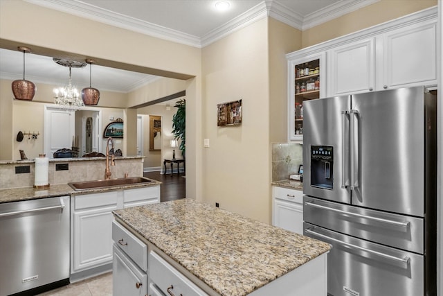 3351 Cascades Ct Unit 306, Tyler, TX 75709 - kitchen featuring stainless steel appliances, a sink, light stone counters, and ornamental molding