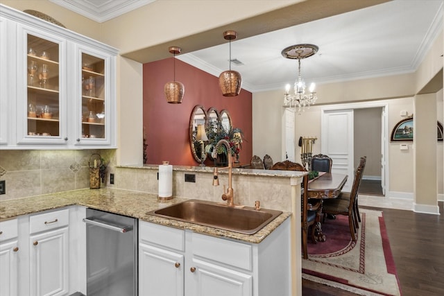 3351 Cascades Ct Unit 306, Tyler, TX 75709 - kitchen featuring a sink, a peninsula, white cabinetry, decorative backsplash, and crown molding