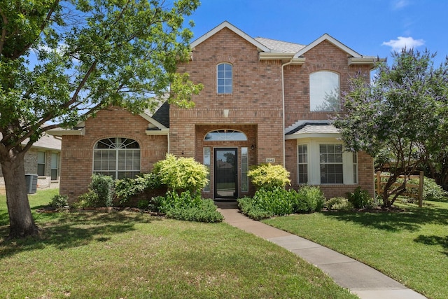 3942 Luke Ln, Carrollton, TX 75007 - traditional-style home featuring brick siding and a front lawn