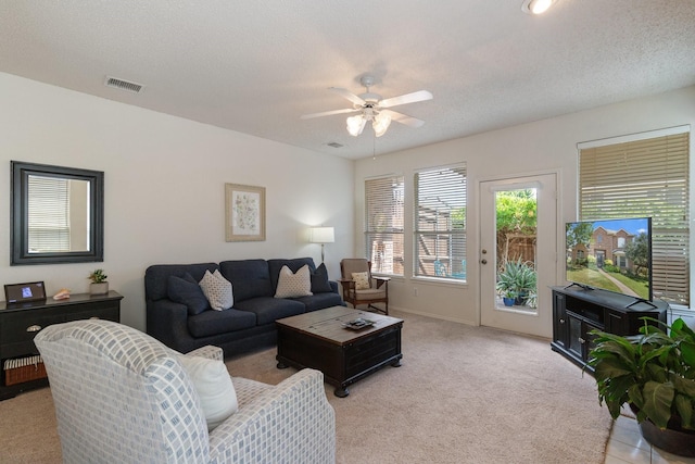 3942 Luke Ln, Carrollton, TX 75007 - living area featuring light colored carpet, a ceiling fan, and baseboards