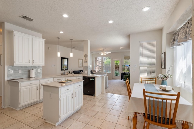 3942 Luke Ln, Carrollton, TX 75007 - kitchen featuring black dishwasher, a peninsula, light countertops, light tile patterned flooring, and open floor plan