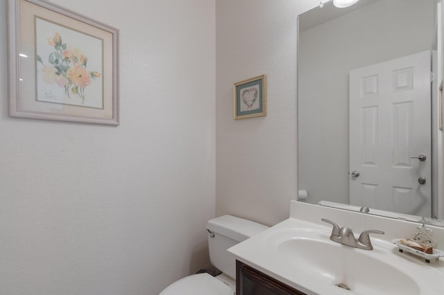 3942 Luke Ln, Carrollton, TX 75007 - half bathroom featuring toilet and vanity