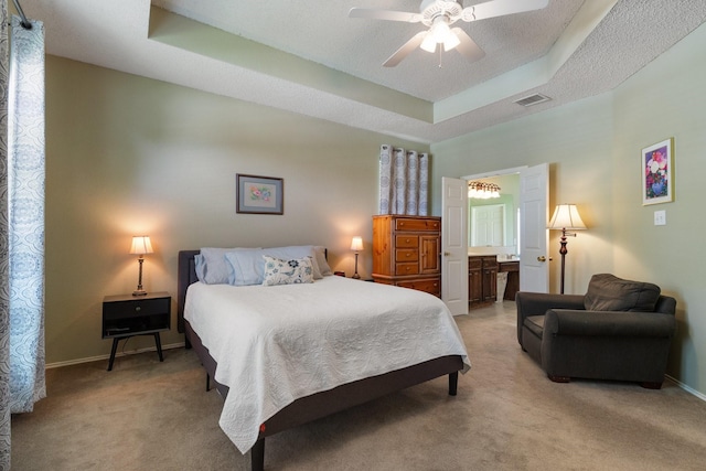 3942 Luke Ln, Carrollton, TX 75007 - bedroom featuring a raised ceiling, light carpet, baseboards, ceiling fan, and ensuite bath
