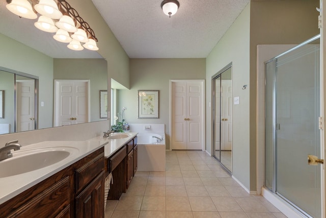 3942 Luke Ln, Carrollton, TX 75007 - bathroom featuring a textured ceiling, a stall shower, double vanity, tile patterned flooring, and a garden tub