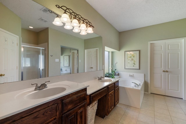 3942 Luke Ln, Carrollton, TX 75007 - bathroom featuring a stall shower, double vanity, a bath, tile patterned floors, and a textured ceiling