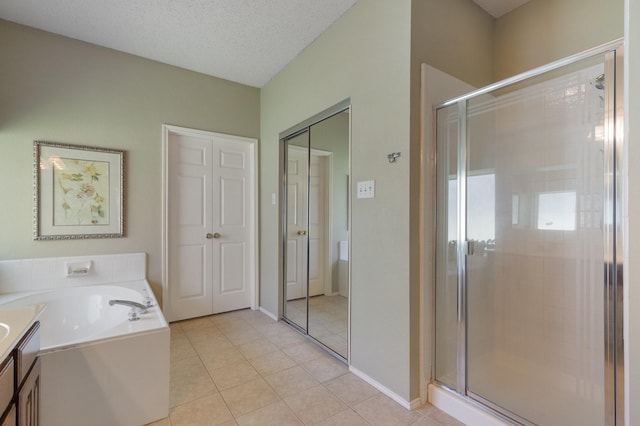 3942 Luke Ln, Carrollton, TX 75007 - full bath with a shower stall, a bath, tile patterned flooring, vanity, and a textured ceiling