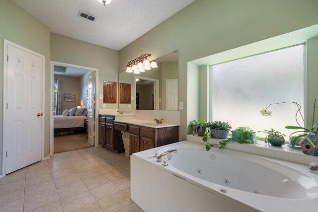 3942 Luke Ln, Carrollton, TX 75007 - ensuite bathroom with a tub with jets, double vanity, tile patterned flooring, and a textured ceiling