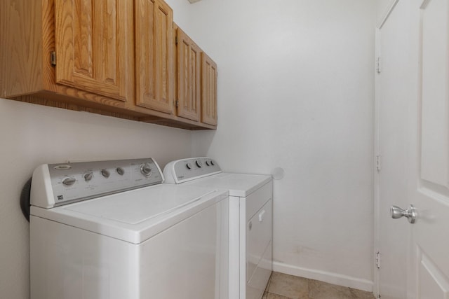 3942 Luke Ln, Carrollton, TX 75007 - laundry room with cabinet space, washing machine and dryer, light tile patterned floors, and baseboards