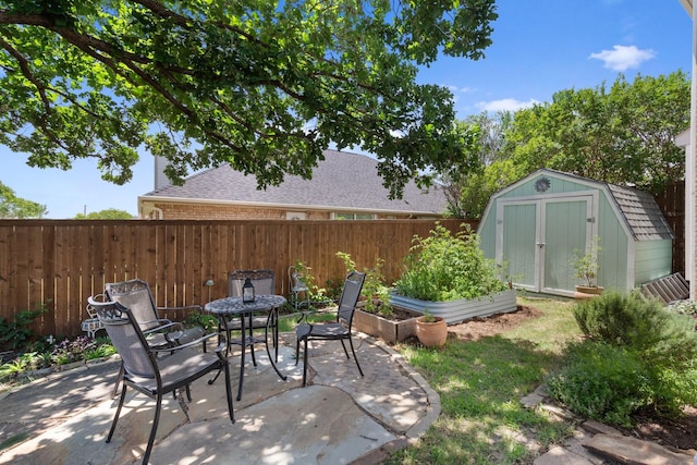 3942 Luke Ln, Carrollton, TX 75007 - fenced backyard with a patio area and a vegetable garden