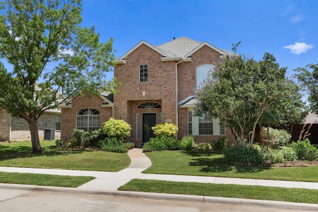 3942 Luke Ln, Carrollton, TX 75007 - traditional-style house featuring a front lawn and brick siding