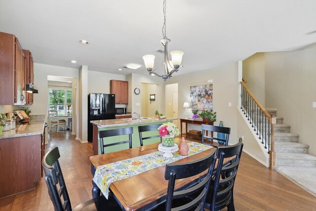 5321 Threshing Dr, Fort Worth, TX 76179 - dining space with a chandelier, stairs, wood finished floors, baseboards, and recessed lighting