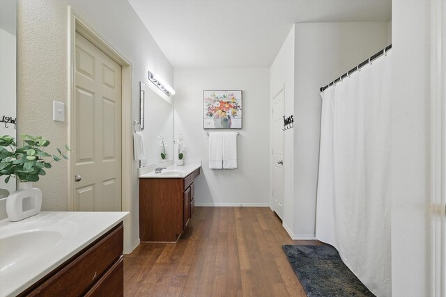 5321 Threshing Dr, Fort Worth, TX 76179 - full bathroom featuring two vanities, wood finished floors, baseboards, and a shower with shower curtain