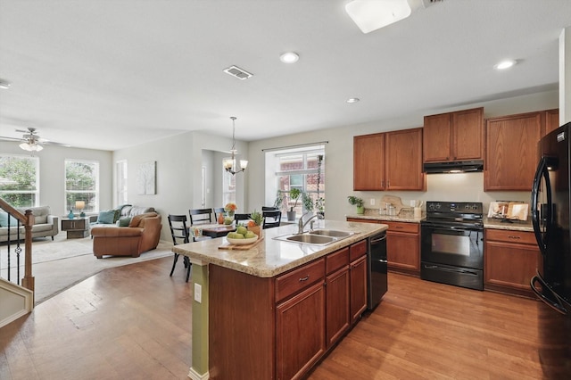 5321 Threshing Dr, Fort Worth, TX 76179 - kitchen featuring black appliances, a sink, under cabinet range hood, light wood-type flooring, and recessed lighting