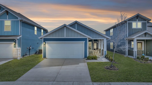 2105 Rolling Wild Rd, Forney, TX 75126 - view of front facade with board and batten siding, concrete driveway, a yard, and an attached garage