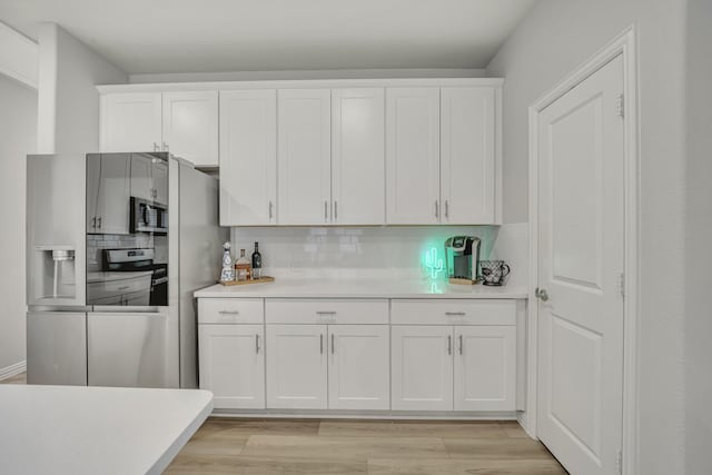 2105 Rolling Wild Rd, Forney, TX 75126 - kitchen featuring light countertops, white cabinetry, backsplash, and light wood-style flooring