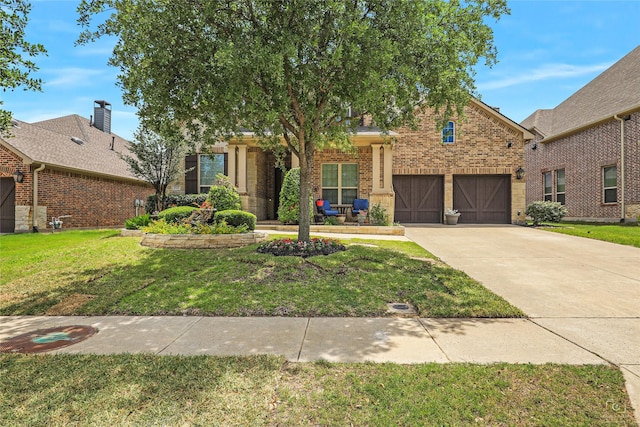 955 Champions Way, Roanoke, TX 76262 - view of front of home featuring driveway, a front yard, and brick siding