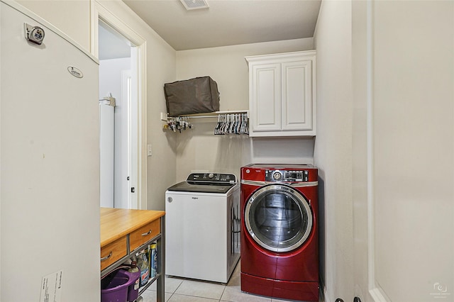 955 Champions Way, Roanoke, TX 76262 - washroom featuring separate washer and dryer, cabinet space, and light tile patterned floors