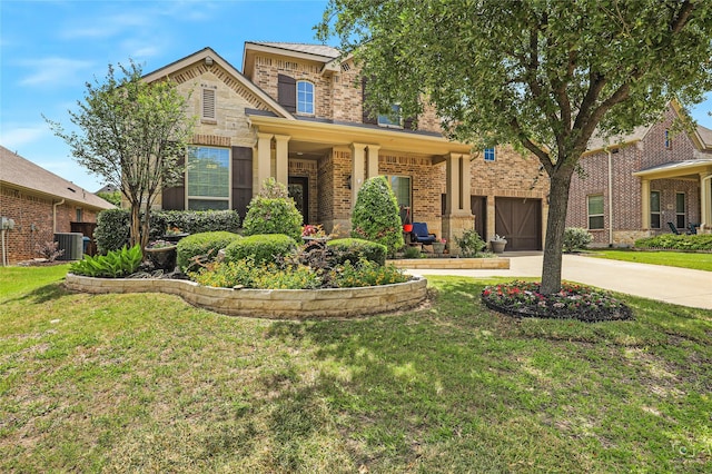 955 Champions Way, Roanoke, TX 76262 - view of front of property with brick siding, central air condition unit, a garage, driveway, and a front lawn