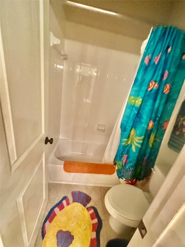955 Champions Way, Roanoke, TX 76262 - bathroom with tile patterned floors, shower / bath combo with shower curtain, and toilet