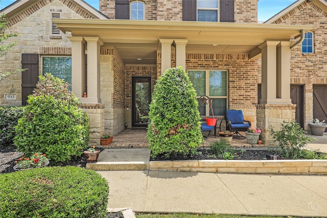 955 Champions Way, Roanoke, TX 76262 - doorway to property with brick siding and covered porch