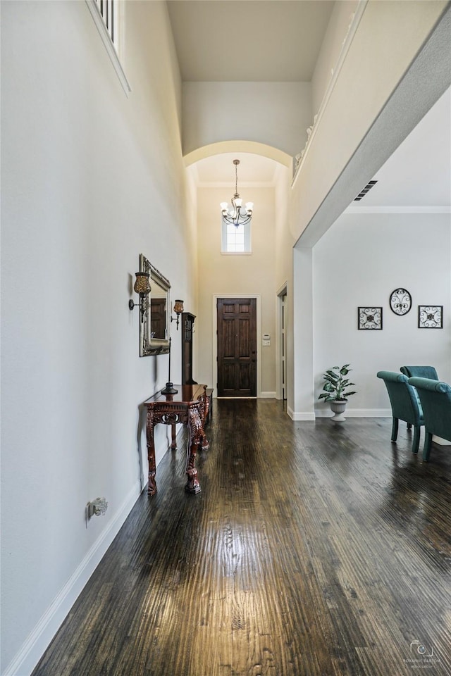 955 Champions Way, Roanoke, TX 76262 - foyer entrance featuring arched walkways, a chandelier, hardwood / wood-style flooring, a high ceiling, and baseboards