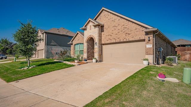 1715 Swale Ln, Granbury, TX 76049 - view of front of property with brick siding, a garage, driveway, and central air condition unit