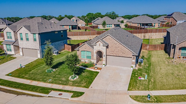 1715 Swale Ln, Granbury, TX 76049 - view of front of property featuring concrete driveway, a residential view, stone siding, and brick siding