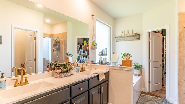 1715 Swale Ln, Granbury, TX 76049 - full bath featuring a shower stall, double vanity, a spacious closet, and a bath